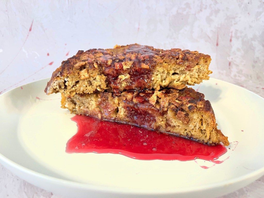 Two extra thick slices of french toast covered in a spooky red win sauce.